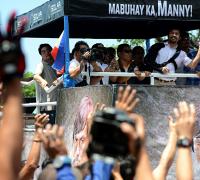 Crowds welcome defiant Manny Pacquiao on return to Philippines